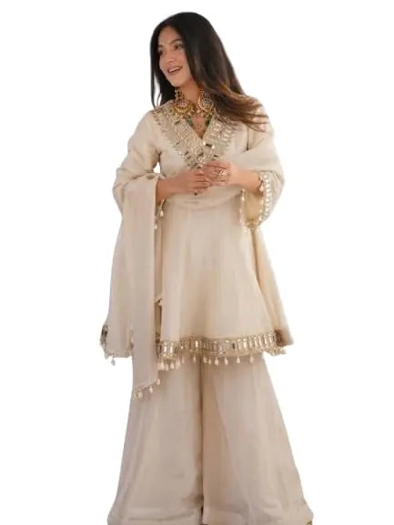Women's Off-White Silk Blend Sharara Suit Set – Short Peplum Kurta with Heavy Mirror Work V-Neck & Shell Tassels – Designer Ethnic with Dupatta – Cream/Ivory Desi Diva