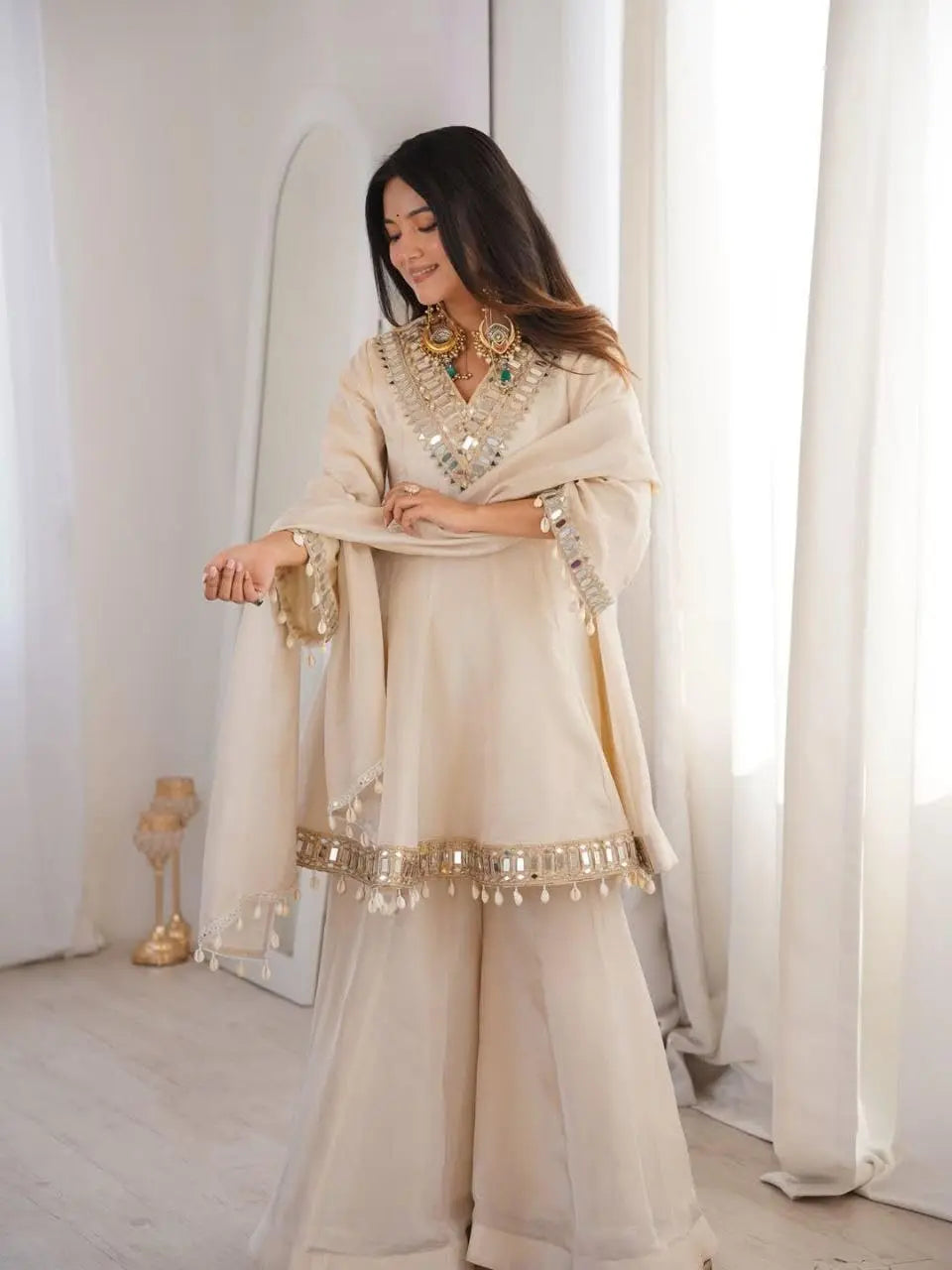 Women's Off-White Silk Blend Sharara Suit Set – Short Peplum Kurta with Heavy Mirror Work V-Neck & Shell Tassels – Designer Ethnic with Dupatta – Cream/Ivory Desi Diva