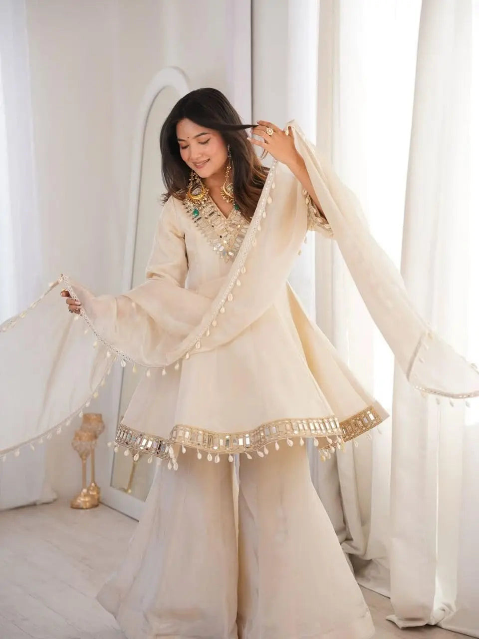 Women's Off-White Silk Blend Sharara Suit Set – Short Peplum Kurta with Heavy Mirror Work V-Neck & Shell Tassels – Designer Ethnic with Dupatta – Cream/Ivory Desi Diva