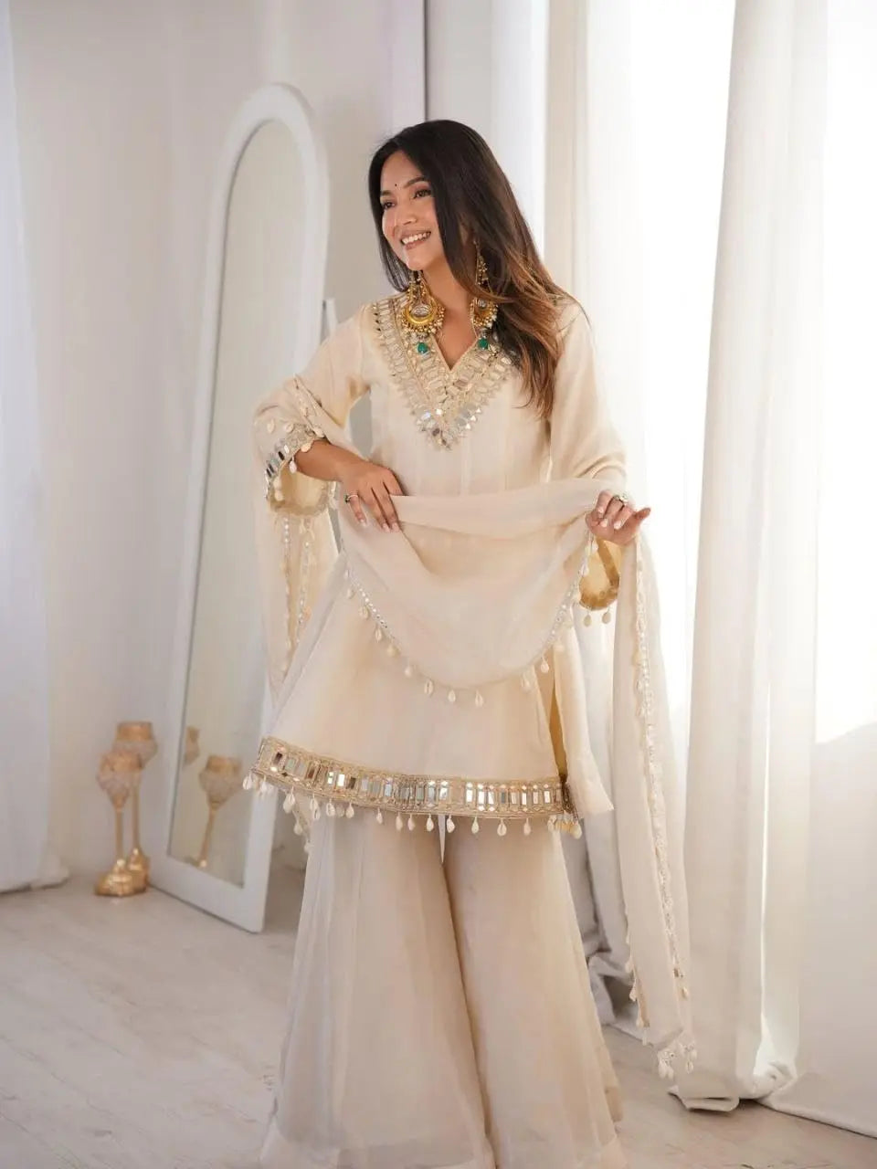 Women's Off-White Silk Blend Sharara Suit Set – Short Peplum Kurta with Heavy Mirror Work V-Neck & Shell Tassels – Designer Ethnic with Dupatta – Cream/Ivory Desi Diva