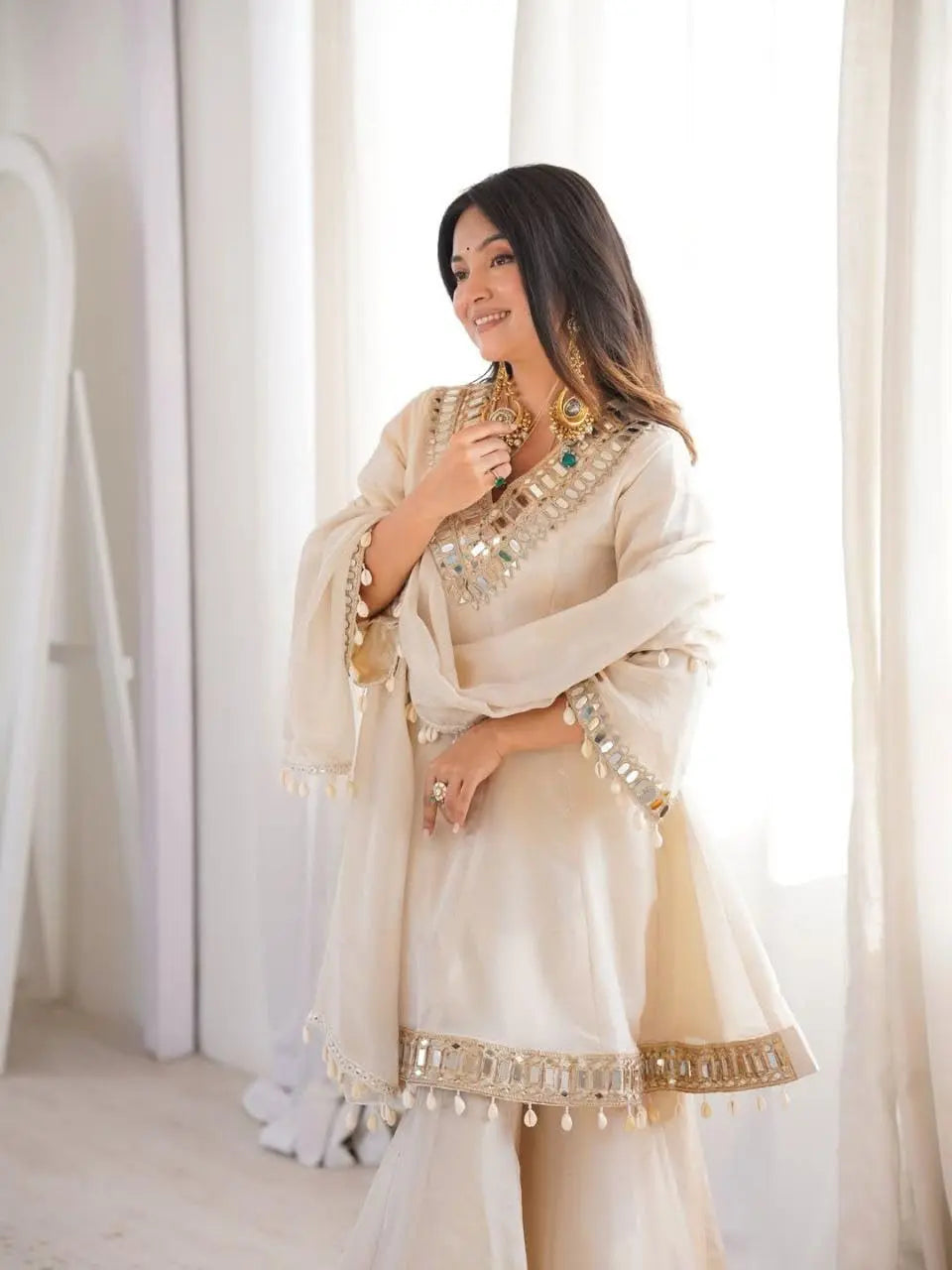 Women's Off-White Silk Blend Sharara Suit Set – Short Peplum Kurta with Heavy Mirror Work V-Neck & Shell Tassels – Designer Ethnic with Dupatta – Cream/Ivory Desi Diva
