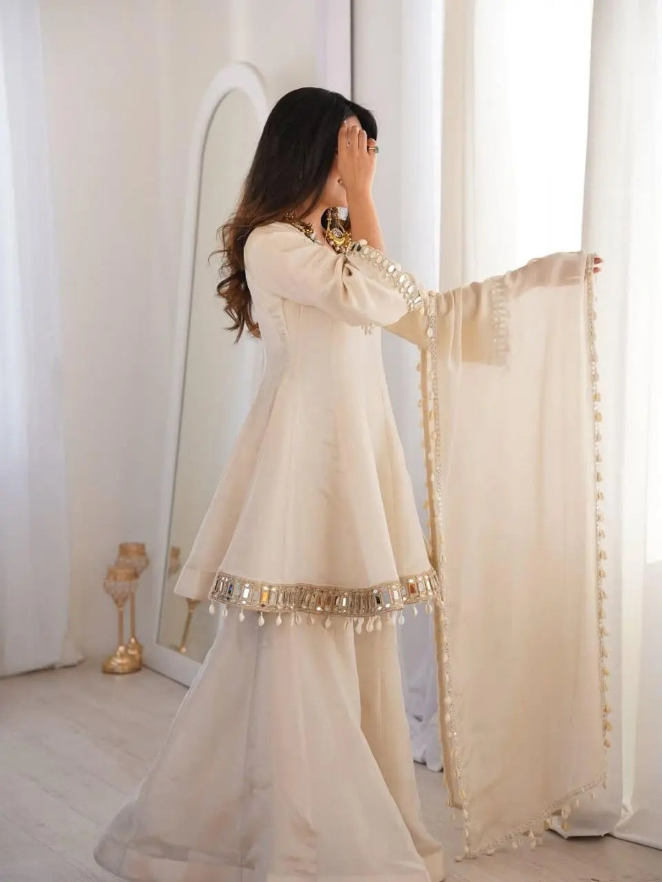 Women's Off-White Silk Blend Sharara Suit Set – Short Peplum Kurta with Heavy Mirror Work V-Neck & Shell Tassels – Designer Ethnic with Dupatta – Cream/Ivory Desi Diva